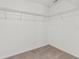 Walk-in closet with wire shelving for organized storage and carpet flooring at 9768 Pembrooke Pines Dr, Sun City Center, FL 33573