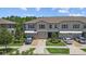 Townhome exterior with well-maintained lawns, driveways, and landscaped gardens at 9768 Pembrooke Pines Dr, Sun City Center, FL 33573