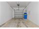 Spacious two car garage, showing cement floor and open garage door at 9768 Pembrooke Pines Dr, Sun City Center, FL 33573