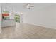 Expansive living area with neutral tile flooring that offers ample space for entertaining and relaxation at 9768 Pembrooke Pines Dr, Sun City Center, FL 33573
