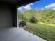 Patio overlooking green space and mature trees creating a private backyard setting at 9768 Pembrooke Pines Dr, Sun City Center, FL 33573