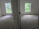 Spacious bedroom with carpet and windows showcasing outdoor views at 9958 Ashburn Lake Dr, Tampa, FL 33610