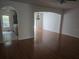 Inviting living room with hardwood floors, arched doorways, and a view into the kitchen at 9958 Ashburn Lake Dr, Tampa, FL 33610