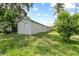 Expansive backyard with lush green lawn surrounding the exterior of the home, offering privacy at 1004 Osage St, Clearwater, FL 33755