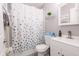 Bright bathroom with modern fixtures, stylish shower curtain, and ample storage at 1004 Osage St, Clearwater, FL 33755