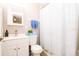 Bright bathroom with modern fixtures, stylish shower curtain, and ample storage at 1004 Osage St, Clearwater, FL 33755