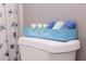 A blue decoration reading, 'Beach Bum' rests on top of the toilet in the bathroom at 1004 Osage St, Clearwater, FL 33755