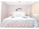 Bright bedroom showcasing a comfortable bed with a blue 'Summer' pillow and neutral decor at 1004 Osage St, Clearwater, FL 33755