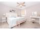 Bright bedroom with bed, bench, and vanity table, featuring neutral tones and natural light at 1004 Osage St, Clearwater, FL 33755