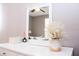 Bright bedroom dresser featuring a white-framed mirror and decorative vase arrangement at 1004 Osage St, Clearwater, FL 33755