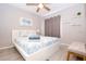 Comfortable bedroom showcasing a bed with blue accents, neutral walls, and stylish decor at 1004 Osage St, Clearwater, FL 33755