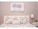 Bedroom featuring a comfortable bed with decorative pillows and a serene floral art piece at 1004 Osage St, Clearwater, FL 33755