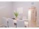Bright dining room features white table, striped chairs, and neutral decor at 1004 Osage St, Clearwater, FL 33755