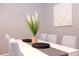 Dining room with a white table, striped chairs, and decorative vase centerpiece at 1004 Osage St, Clearwater, FL 33755