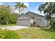 Charming single-story home featuring a well-maintained lawn, attached garage, and attractive curb appeal at 1004 Osage St, Clearwater, FL 33755