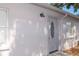 The side entrance of the home featuring a white front door at 1004 Osage St, Clearwater, FL 33755