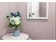 A beautiful vase of flowers decorates a white table in the hallway at 1004 Osage St, Clearwater, FL 33755