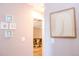 Hallway adorned with coastal-themed artwork leading to a comfortable living area at 1004 Osage St, Clearwater, FL 33755