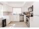 Modern kitchen features white cabinets, stainless steel appliances, and hardwood floors at 1004 Osage St, Clearwater, FL 33755