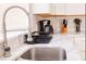 Modern kitchen features stainless steel sink and countertops with matching appliances at 1004 Osage St, Clearwater, FL 33755