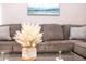 Stylish living room showcasing a comfortable sofa, decorative vase, and coastal artwork at 1004 Osage St, Clearwater, FL 33755