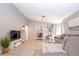 Large living room boasts a modern design with a sectional sofa, hanging chair, and open floor plan at 1004 Osage St, Clearwater, FL 33755