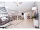 Open-concept living room with modern furnishings, including a hanging chair and sectional sofa at 1004 Osage St, Clearwater, FL 33755