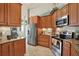 Modern kitchen with stainless steel appliances, tile backsplash, and granite countertops at 10597 Alvarado Ct, Seminole, FL 33772
