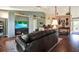 Inviting living room with a large TV, hardwood floors, and plenty of seating at 10597 Alvarado Ct, Seminole, FL 33772