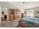 Spacious main bedroom featuring a ceiling fan, window shutters, and carpeted flooring at 10597 Alvarado Ct, Seminole, FL 33772