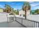 A fenced backyard offers a private deck, and access to the garage and additional apartment at 108 5Th Ave, St Pete Beach, FL 33706