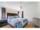 Relaxing bedroom featuring a dark wood headboard, turtle bedding, side tables, and soft natural light creating a cozy retreat at 108 5Th Ave, St Pete Beach, FL 33706