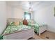 Charming bedroom featuring two cozy beds, a wooden dresser, and tropical-themed bedding, creating a relaxing getaway at 108 5Th Ave, St Pete Beach, FL 33706