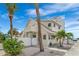 White single-Gathering home with a fenced yard and palm trees in a beach community at 108 5Th Ave, St Pete Beach, FL 33706