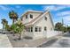 Charming two-story home with a white picket fence and tropical landscaping at 108 5Th Ave, St Pete Beach, FL 33706