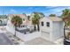 Aerial view of white single-Gathering home featuring fenced yard, private deck, garage and additional apartment at 108 5Th Ave, St Pete Beach, FL 33706