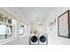 Bright laundry room with modern washer and dryer, plenty of natural light, and stylish coastal-themed decor at 108 5Th Ave, St Pete Beach, FL 33706