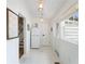 Bright mud room with marble floors, updated lighting, convenient stairs access, and direct access to the outside at 108 5Th Ave, St Pete Beach, FL 33706