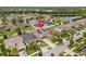 Aerial view of a suburban neighborhood with solar panels on the roof and well-maintained yards at 11024 Purple Martin Blvd, Riverview, FL 33579