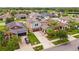 Aerial view of a home with solar panels, a manicured lawn, and a convenient two-car garage at 11024 Purple Martin Blvd, Riverview, FL 33579