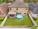 A spacious, green backyard featuring a above-ground pool and a covered patio at 11024 Purple Martin Blvd, Riverview, FL 33579