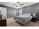This bedroom features carpet, ceiling fan, natural light and dark accent wall at 11024 Purple Martin Blvd, Riverview, FL 33579