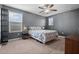 Bedroom features carpet, ceiling fan, and natural light with large windows at 11024 Purple Martin Blvd, Riverview, FL 33579