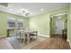 The dining room is lit by a ceiling fan and natural light from windows at 11024 Purple Martin Blvd, Riverview, FL 33579
