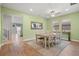 Dining room with seating for six and natural light from large windows at 11024 Purple Martin Blvd, Riverview, FL 33579