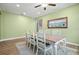 A well-lit dining room with modern furniture and views of the staircase at 11024 Purple Martin Blvd, Riverview, FL 33579