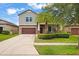 Charming two-story home featuring a well-manicured lawn and covered front porch at 11024 Purple Martin Blvd, Riverview, FL 33579