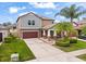 Lovely two-story home with lush landscaping, a spacious driveway, and a welcoming front porch at 11024 Purple Martin Blvd, Riverview, FL 33579