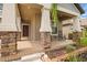 Close-up of covered porch with brick pillars, rocking chairs, and a brick-paved porch floor at 11024 Purple Martin Blvd, Riverview, FL 33579
