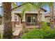 Inviting covered porch featuring classic rocking chairs, brick accents, and fresh landscaping at 11024 Purple Martin Blvd, Riverview, FL 33579